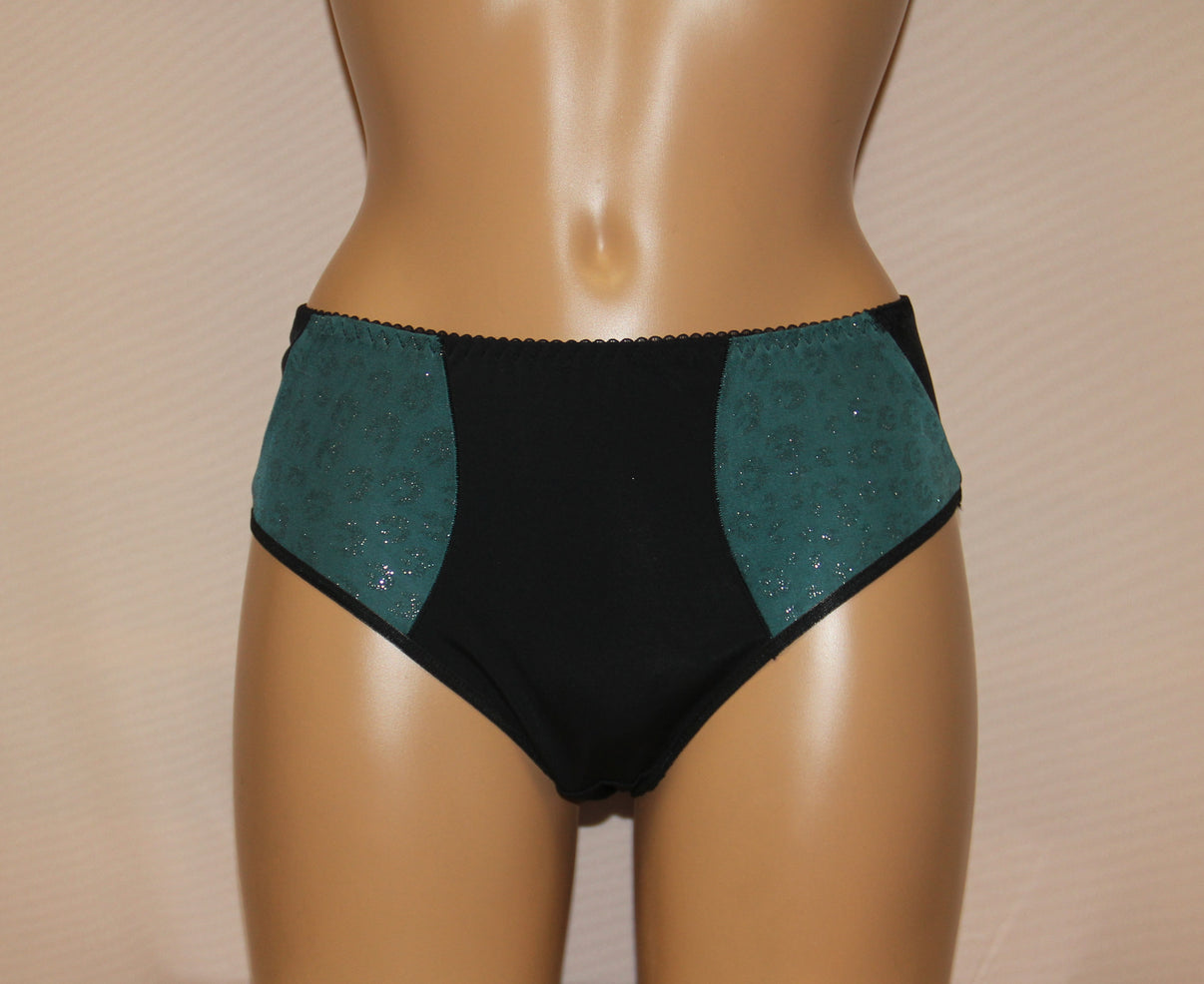 A pair of women's classic panties with a green minimalistic pattern on the side panels.