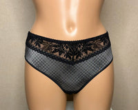 Women's black panties with a geometric pattern.