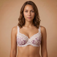 Woman wearing a lace bralette against a beige background