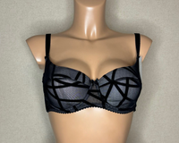 A black padded balconette bra, showing adjustable straps and a patterned fabric.