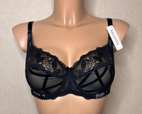 A black soft cup bra with underwires and side support, featuring a geometric pattern and lace detailing.