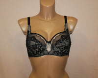 A black lace soft cup bra with side support. It has adjustable straps.