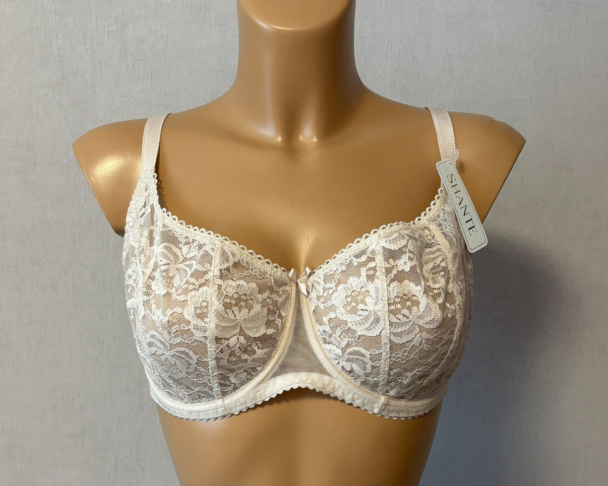 A light beige women's soft cup bra with underwired support and lace cups, with adjustable straps.