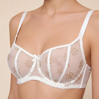 Ivory lace bra on a beige background