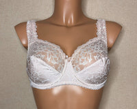 A light beige color soft cup bra with floral pattern.