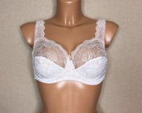 A light beige color soft cup bra with floral pattern.