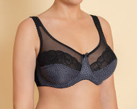 A woman's soft cup multi-colored bra with dot print, featuring adjustable straps and underwired support.