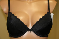 A black push-up bra, featuring underwired support, cotton lining on cups, and adjustable straps.