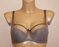 A brown, half-padded, underwired bra with adjustable straps.