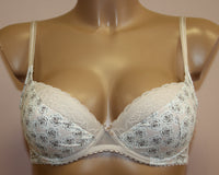 A beige-coloured push-up bra with floral pattern.