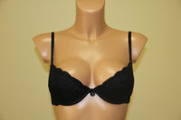 A black push-up bra, featuring underwired support, cotton lining on cups, and adjustable straps.