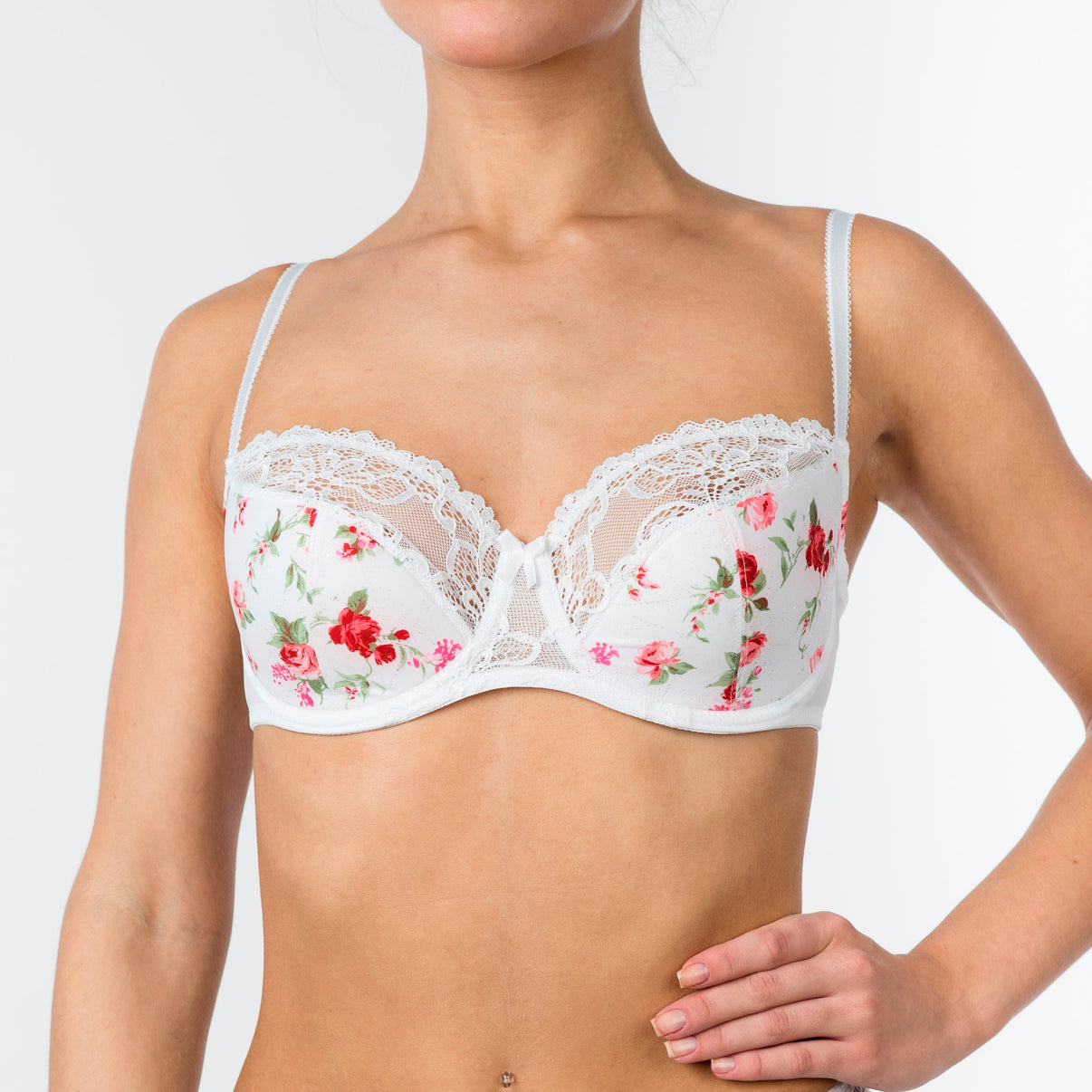 A white, half padded, floral patterned bra with adjustable straps and underwired support.