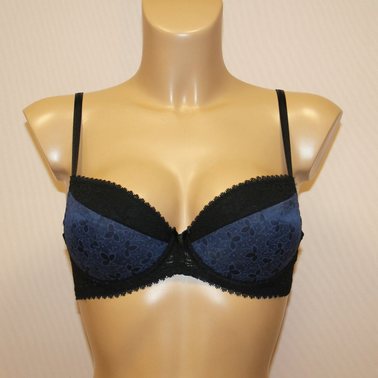 Blue push-up bra featuring underwired support, cotton lining on cups, and adjustable straps.